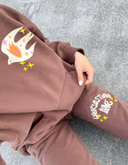 Elevated Faith brown sweatpants featuring dove design and Christian Apparel theme for casual wear