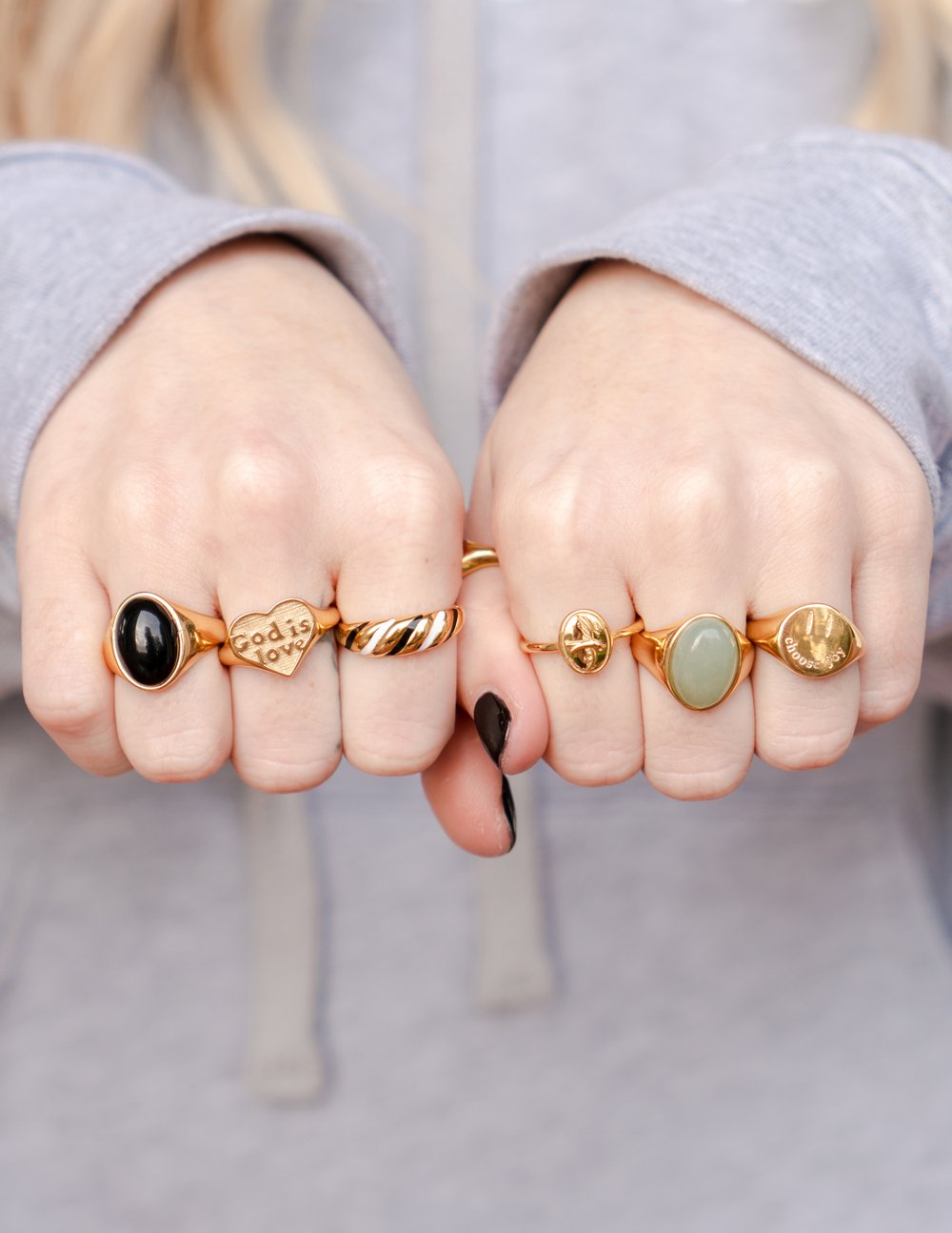 Assorted gold rings from Elevated Faith featuring designs perfect for Christian jewelry
