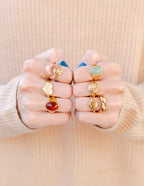 Elevated Faith Christian Jewelry rings in various designs and colors displayed on model's hands