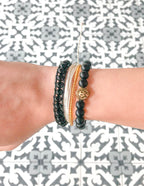Elevated Faith Christian Bracelet Stack featuring black and gold string designs for a stylish and meaningful accessory