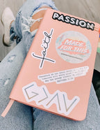 Christian Stickers on a pink notebook, featuring messages of faith and positivity