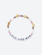 Elevated Faith Christian Jewelry Bracelet featuring colorful beads and letters spelling 'LOVE HAS WON'