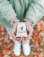 Elevated Faith Christian Bracelet displayed with a stylish pouch against a fall backdrop