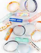 Variety of colorful Elevated Faith wristbands featuring inspiring messages, suitable as Christian Jewelry Bracelet