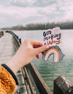 Christian Stickers featuring a colorful rainbow and uplifting text against a scenic backdrop