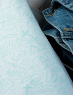 Elevated Faith Packaging with Light Blue Christian Apparel Designs Including Faith and Love Symbols