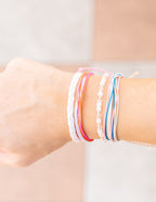 Set of colorful Elevated Faith Christian Jewelry Bracelet worn on a wrist, showcasing layered designs