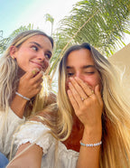 Two friends wearing Elevated Faith Christian Jewelry Bracelets, showcasing a playful and stylish look