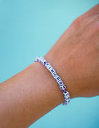 Elevated Faith Christian Jewelry Bracelet with white and purple letter beads spelling out KINGDOM.